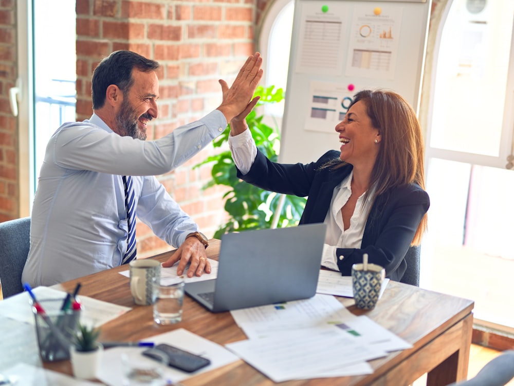 Two colleagues talking through a plan together at a desk