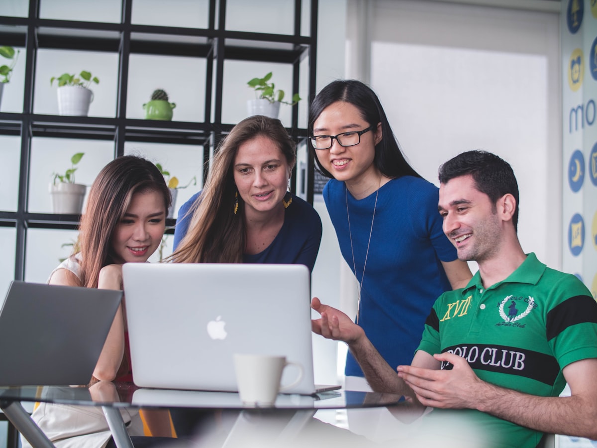 A team reviewing website designs together on a laptop