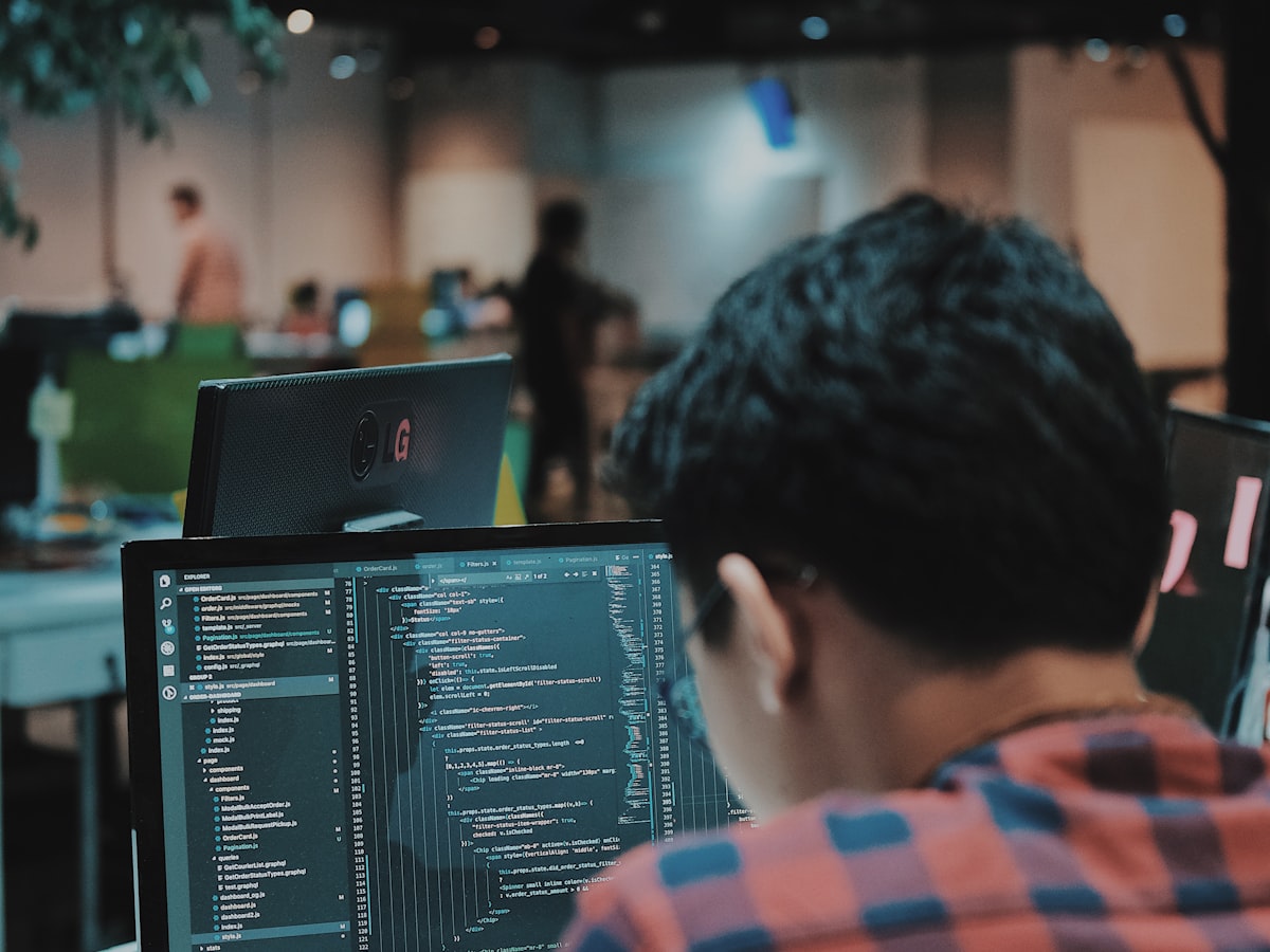A developer working through code on a monitor