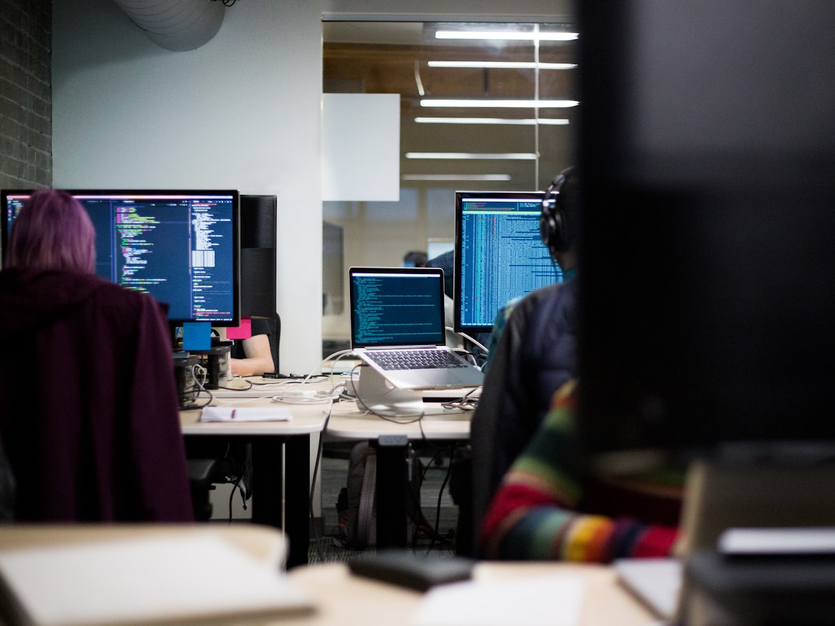 Dual monitors showing a website being built and previewed